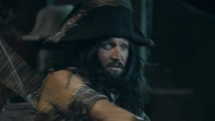 Two glamorous pirate strumpets are in a threesome on the captains daybed