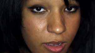 A dark Latin babe with a nice-looking face is engulfing and licking a cock